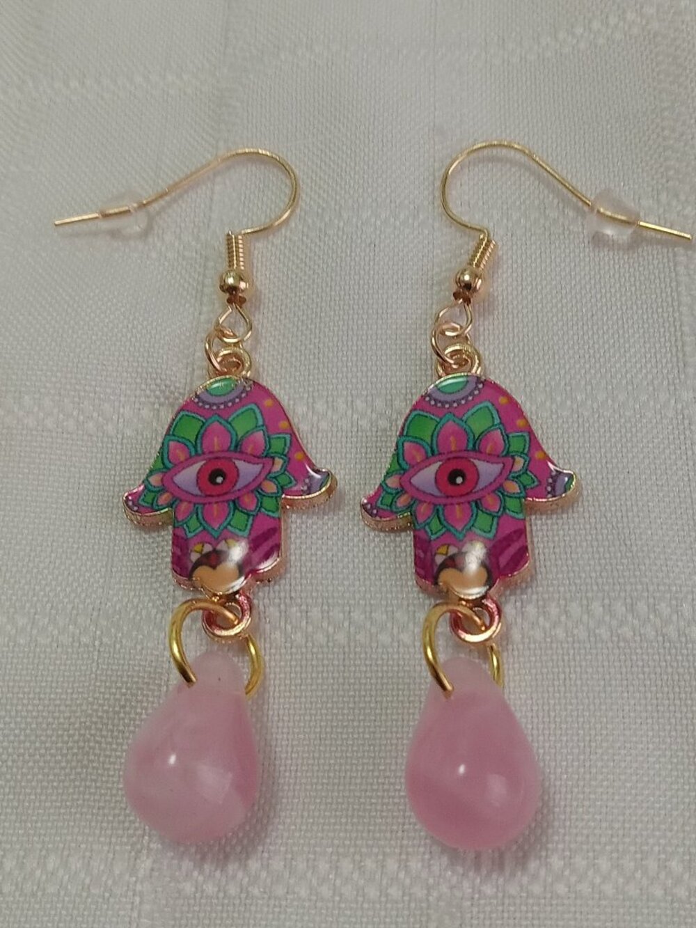 Handmade gold-colored earrings with multicolored enameled fatima hands and beads